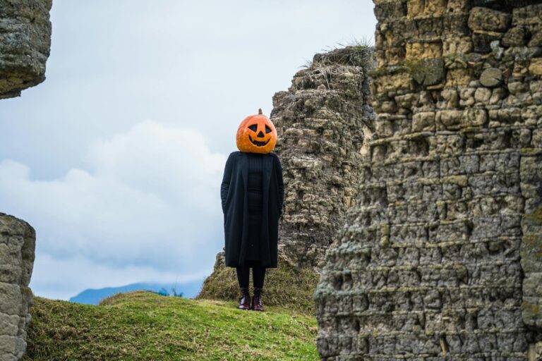 A person with a pumpkin head stands among ancient ruins in Guasca, Colombia.