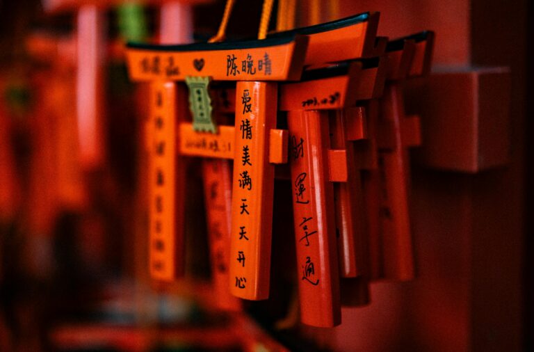 Close-up of vibrant orange votive Torii gates at Fushimi Inari Shrine in Kyoto, Japan.